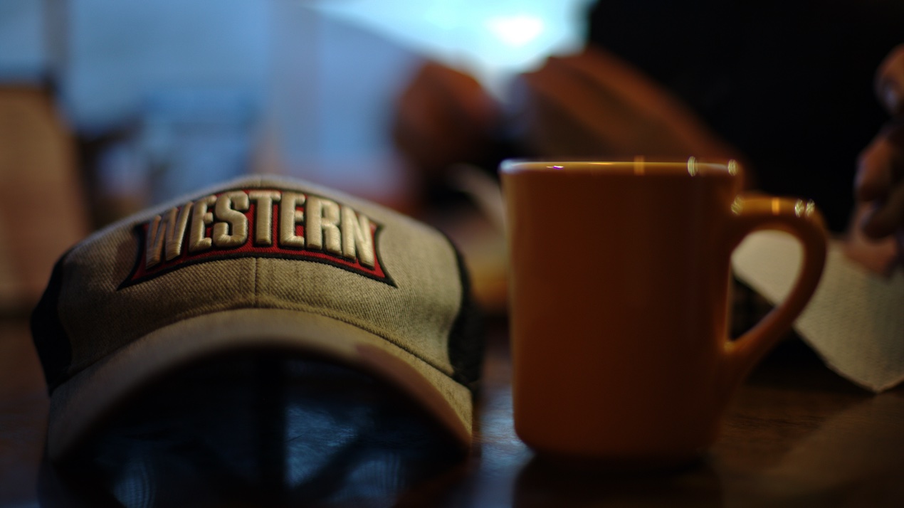 Western hat next to a coffee mug